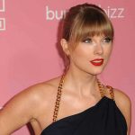 Woman with red lipstick in front of pink background.