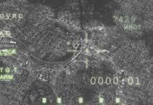 Aerial view through night vision targeting display.