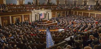 Washington Divided Over China AI Sales People in a large government assembly hall meeting
