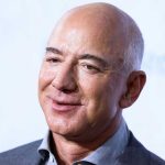 Smiling bald man in a suit.