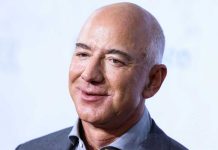 Smiling bald man in a suit.