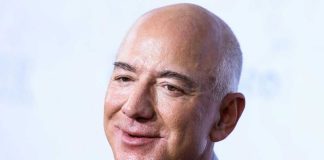 Tech Titans, Not Voters? Bezos’ Paris Speech Sparks Debate Smiling bald man in a suit.