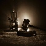 Gavel and electric chair in dimly lit room