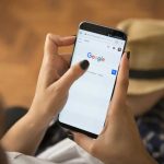 EU Judges Drop A Bomb On Google Person using smartphone with Google search page displayed