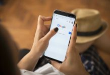 Person using smartphone with Google search page displayed