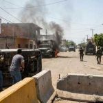 Quake Chaos: Cops Caught Looting Scene of urban conflict with military vehicles and overturned cars