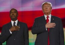 Two men in formal attire standing with hands over their hearts