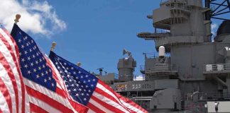 New Allied Strategy Targets Gray Zone Tactics American flags in front of a naval ship under a blue sky