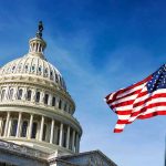 Christian Nation Claim Hits Founders’ Wall U.S. Capitol building with American flag in foreground.