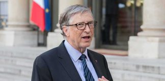 The AI Voice Scam That’s Fooling Families Across America A man in a suit speaking outdoors near a building