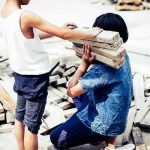 Children Trapped as Haiti Falls to Gang Violence two children handling wooden planks at a work site
