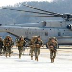 The Fight Over What America Is Told About War Soldiers disembark and walk past a large military helicopter