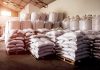 Stacked white sacks on pallets in a warehouse