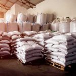 War’s Hidden Cost: One Shop Lost 90% of Its Customers Stacked white sacks on pallets in a warehouse