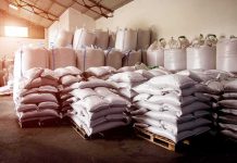 Stacked white sacks on pallets in a warehouse