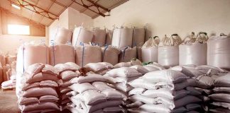 Stacked white sacks on pallets in a warehouse