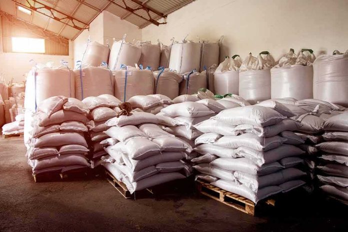 Stacked white sacks on pallets in a warehouse