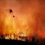 Madrid Wildfires Merge Into a Massive Fire Front Helicopter fights massive wildfire over burning forest