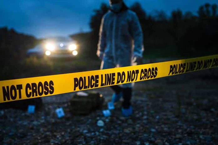 shutterstock_2059864061 crime scene with yellow police line tape at night