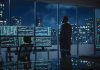 Trader in a dark office with multiple stock monitors and city skyline at night