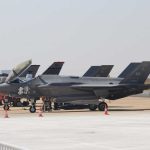F-35 Radar Delay Raises Bigger Questions F-35 military jets parked on an airfield with crew members nearby