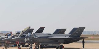 F-35 Radar Delay Raises Bigger Questions F-35 military jets parked on an airfield with crew members nearby