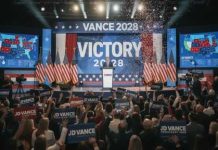 A political rally celebrating a victory with supporters holding signs