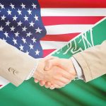 Saudi Enrichment? Washington Plays With Fire Handshake between two people over U.S. and Saudi flags
