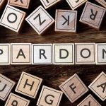 Another Wave of Trump Pardons Sparks Fierce Justice Fight Wooden letter blocks arranged to spell 'PARDON' on a wooden surface