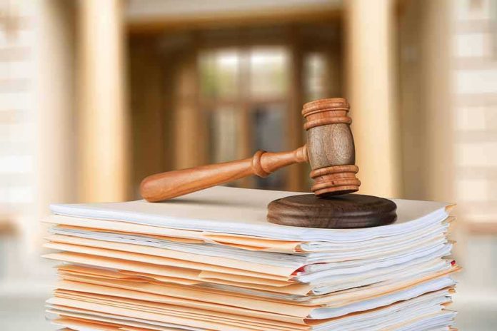 judge's gavel resting on a stack of case files