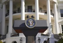 Presidential podium with seal in front of white-columned building