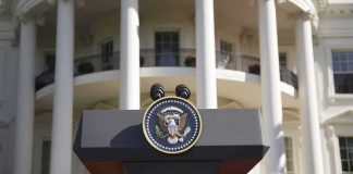 Presidential podium with seal in front of white-columned building