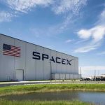 A Land Deal That Could Change SpaceX Forever SpaceX hangar beside launch pad under blue sky
