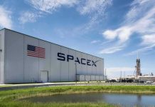 SpaceX hangar beside launch pad under blue sky