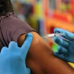 Fauci’s Private Vaccine Warning Collides With Later Reassurances Healthcare worker administering vaccine in upper arm