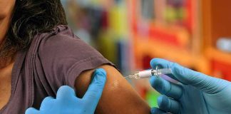 Fauci’s Private Vaccine Warning Collides With Later Reassurances Healthcare worker administering vaccine in upper arm
