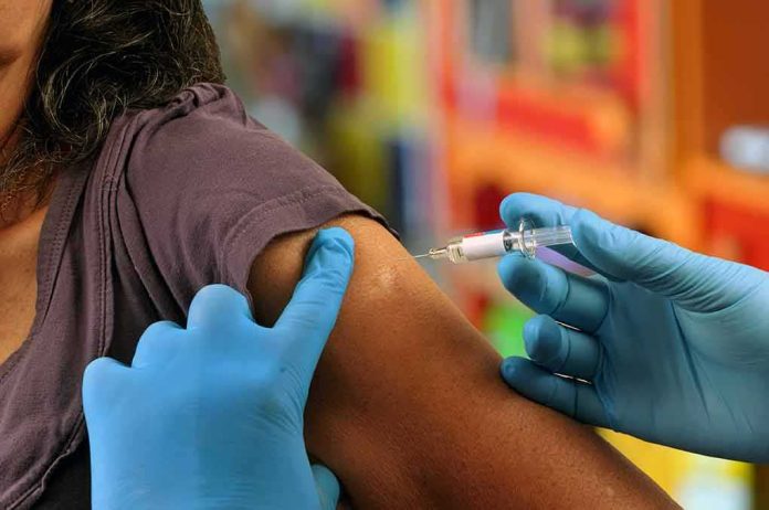 shutterstock_1288816186 Healthcare worker administering vaccine in upper arm