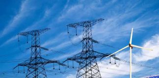 Power lines with wind turbine and solar panels