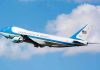 Air Force One aircraft ascending against a blue sky