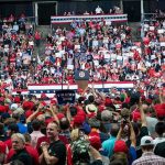 Big Promise Made to America’s Auto Workers Crowd at a political rally facing a podium