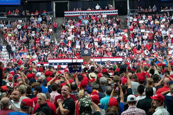 shutterstock_1480255847 Crowd at a political rally facing a podium