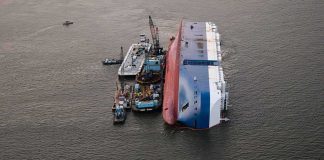 Dozens Missing After Ferry Overturns Capsized cargo ship with salvage vessels alongside