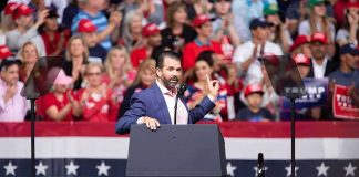 Trump Endorses Komatireddy in High-Stakes Bid Speaker at podium addressing a rally crowd