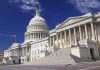 The U.S. Capitol building with its dome and columns under a blue sky