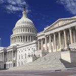 The U.S. Capitol building with its dome and columns under a blue sky