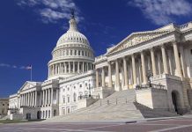 The U.S. Capitol building with its dome and columns under a blue sky