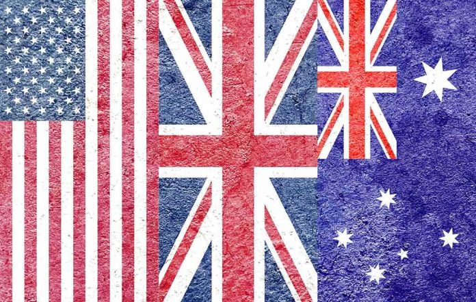 shutterstock_1980702383-1 Composite of the US, UK, and Australian flags with a textured, grunge overlay