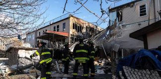 Man Hospitalized After Manhattan Lobby Fire Firefighters assess damage at a collapsed residential building