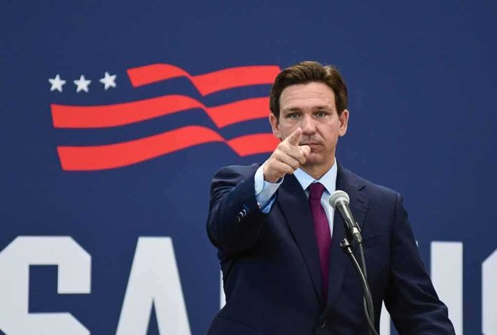shutterstock_2352132667 man in suit pointing while speaking at podium