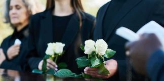 Jorge Messi Dies at 68, Leaving Lionel Messi and Soccer World in Mourning Mourners holding white roses beside a wooden casket
